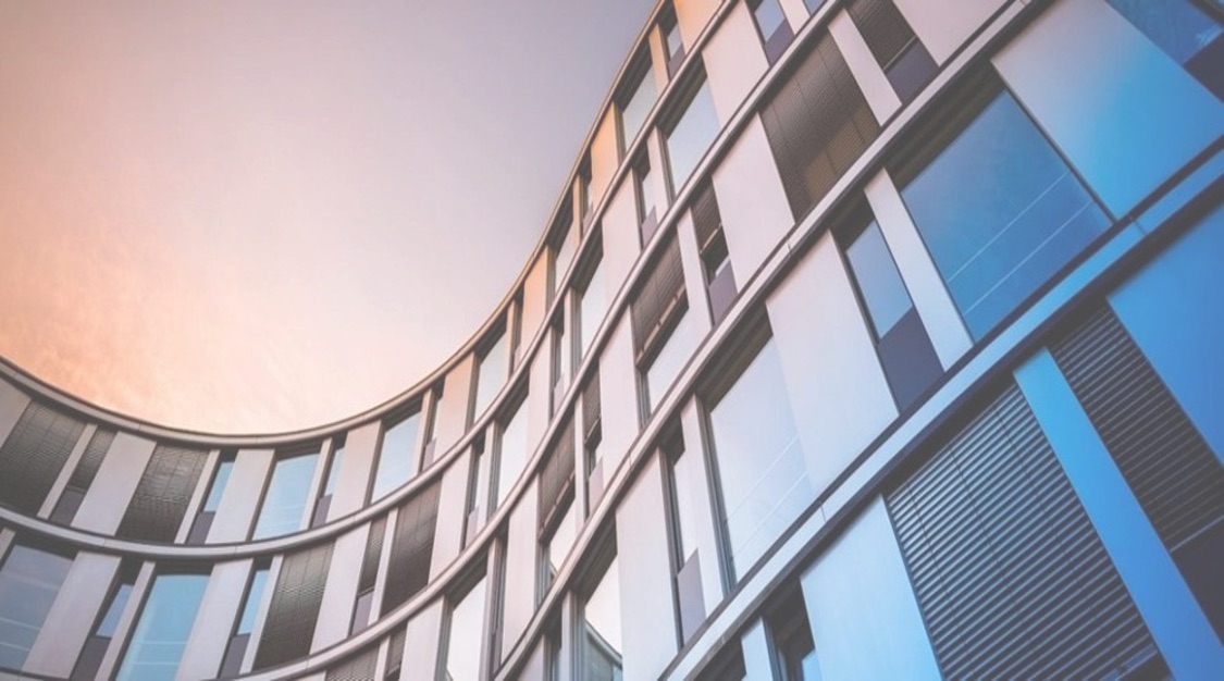 Curved glass facade of a commercial building maintained by GMCS in Western Victoria